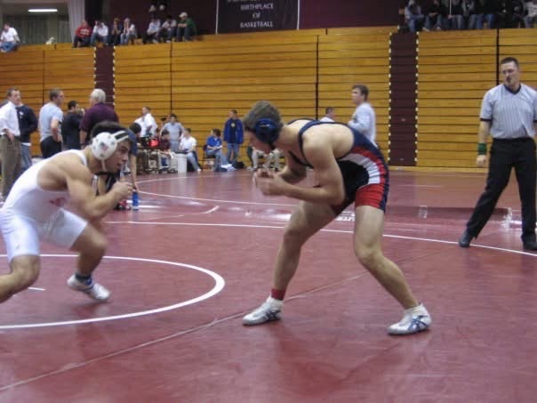 Wrestling stance-off on red mat